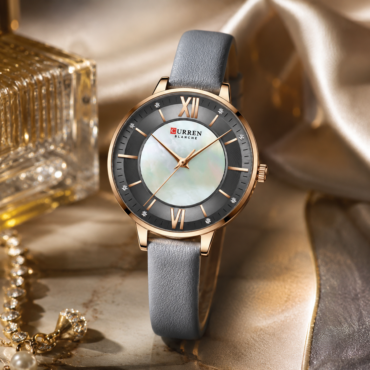 Curren watch with gray strap and gold accents on a reflective surface