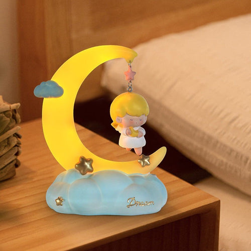 LX EMPIRE Good Night Little Angel night light with a girl sitting on a crescent moon holding a star, on a cloud base.