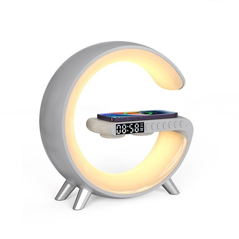 LX EMPIRE G-shaped lamp with wireless charger, Bluetooth speaker, and digital clock display in light grey.