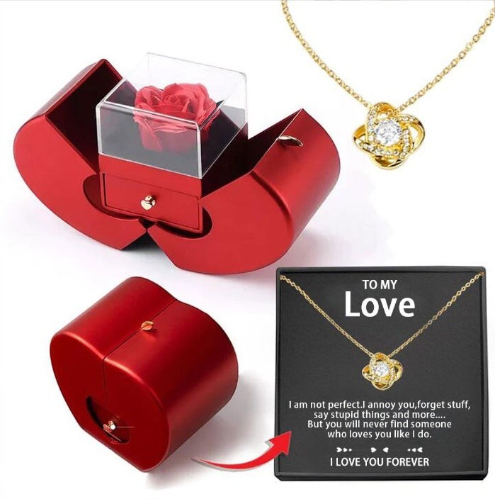 LX EMPIRE red apple-shaped jewelry box with preserved rose and gold necklace featuring a knot pendant with crystal.