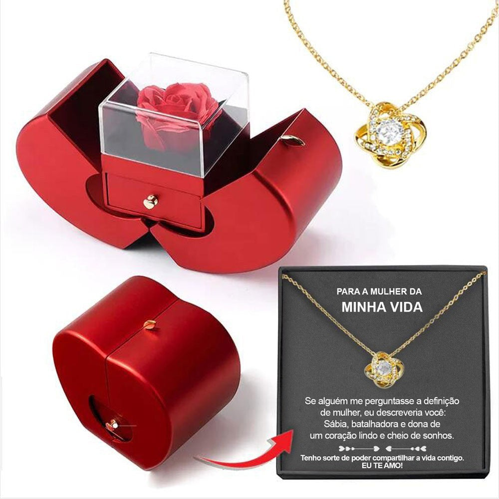 LX EMPIRE red apple-shaped jewelry box with preserved rose and gold knot necklace with crystal pendant.